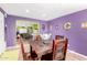 Open dining area with purple walls and view of the living room at 2235 W Villa Rita Dr, Phoenix, AZ 85023