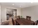 Dining room area featuring wood floors, a wooden dining table, and easy access to the living room at 2235 W Villa Rita Dr, Phoenix, AZ 85023