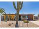 A yellow single-story house featuring desert landscaping with cacti, rock features, and a covered entryway at 2235 W Villa Rita Dr, Phoenix, AZ 85023