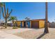 A one-story house in yellow and blue with desert landscaping, garage, and various cacti at 2235 W Villa Rita Dr, Phoenix, AZ 85023