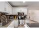 Bright kitchen featuring stainless steel appliances, mosaic backsplash, granite counters, and white cabinets at 2235 W Villa Rita Dr, Phoenix, AZ 85023