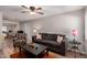 Bright living room features hard wood floors, a ceiling fan, couch, chair, and a view to the kitchen at 2235 W Villa Rita Dr, Phoenix, AZ 85023