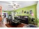 Spacious living room with lime green walls and a view into the kitchen area at 2235 W Villa Rita Dr, Phoenix, AZ 85023