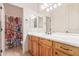 Bathroom with double vanity and floral shower curtain at 22605 W Baker Dr, Wittmann, AZ 85361