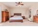 Main bedroom with wood furniture and access to bathroom at 22605 W Baker Dr, Wittmann, AZ 85361