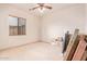 Bedroom with ceiling fan and moving boxes at 22605 W Baker Dr, Wittmann, AZ 85361