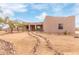 Desert landscape with stucco home, stone pathway, and mature trees at 22605 W Baker Dr, Wittmann, AZ 85361