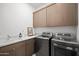 Laundry room with modern washer and dryer, and cabinets at 23491 N 125Th Pl, Scottsdale, AZ 85255