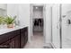 Modern bathroom with double vanity, walk-in shower, and large closet at 25412 N 144Th Dr, Surprise, AZ 85387