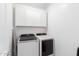 Convenient laundry room with washer, dryer, and upper cabinets at 25412 N 144Th Dr, Surprise, AZ 85387