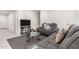 Living room featuring gray sofas and a glass-top coffee table at 25412 N 144Th Dr, Surprise, AZ 85387