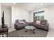 Comfortable living room with gray reclining sofas and a coffee table at 25412 N 144Th Dr, Surprise, AZ 85387