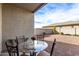 Covered patio with glass-top table and chairs, perfect for outdoor dining at 25412 N 144Th Dr, Surprise, AZ 85387