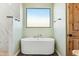 Bathroom with a large, free-standing bathtub and marble tile at 274 E Mckellips Blvd, Apache Junction, AZ 85119