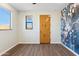 Bedroom with wood door and artistic wall mural at 274 E Mckellips Blvd, Apache Junction, AZ 85119