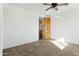 Simple bedroom with carpeted floor and wood door at 274 E Mckellips Blvd, Apache Junction, AZ 85119