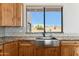 Kitchen boasts a farmhouse sink and wood cabinets at 274 E Mckellips Blvd, Apache Junction, AZ 85119