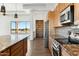 Modern kitchen with wood cabinets, granite counters, and stainless steel appliances at 274 E Mckellips Blvd, Apache Junction, AZ 85119