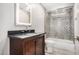 Bathroom with lighted mirror, tub, and shower at 27511 N 33Rd Ave, Phoenix, AZ 85083