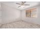 Bright bedroom with ceiling fan and tile floors at 27511 N 33Rd Ave, Phoenix, AZ 85083