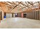 Ample garage space featuring high ceilings and a roll-up door at 27511 N 33Rd Ave, Phoenix, AZ 85083