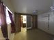 Simple bedroom with barn door entry to bathroom, and window at 303 W 13Th St, Eloy, AZ 85131