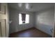 Small bedroom with hardwood floors and a window at 303 W 13Th St, Eloy, AZ 85131