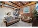 Living room with exposed brick, wooden beams, and couches at 304 W Roosevelt St # 102, Phoenix, AZ 85003