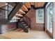 Modern metal staircase with wooden steps and brick walls at 304 W Roosevelt St # 102, Phoenix, AZ 85003