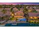 Aerial sunset view of house with pool and lake at 3180 S Greythorne Way, Chandler, AZ 85248