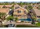 Aerial view of house with pool and lake access at 3180 S Greythorne Way, Chandler, AZ 85248