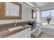 Bathroom with dual sinks, granite counters, and tub at 3180 S Greythorne Way, Chandler, AZ 85248