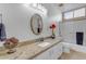 Bathroom boasts granite countertop, updated vanity, and bathtub at 3180 S Greythorne Way, Chandler, AZ 85248