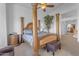 Main bedroom with a large four-poster bed and ensuite bathroom at 3180 S Greythorne Way, Chandler, AZ 85248