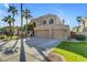 Two-story house with three car garage and manicured lawn at 3180 S Greythorne Way, Chandler, AZ 85248