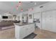 Spacious kitchen with island, white cabinets, and black appliances at 3180 S Greythorne Way, Chandler, AZ 85248