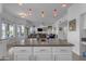 Modern kitchen island with granite countertops, open to living area at 3180 S Greythorne Way, Chandler, AZ 85248