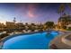 Large, free-form pool with lake view at sunset at 3180 S Greythorne Way, Chandler, AZ 85248