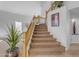 Elegant staircase with wood railings and carpeted steps at 3180 S Greythorne Way, Chandler, AZ 85248