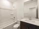 Clean bathroom featuring a shower-tub combo, white vanity with dark wood cabinet and white sink at 3403 E Audrey Dr, San Tan Valley, AZ 85143