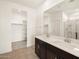 Bathroom featuring double sinks, a large mirror, and a view to the walk-in closet at 3403 E Audrey Dr, San Tan Valley, AZ 85143