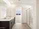 Bathroom featuring double sinks, a glass shower, and a view into the walk-in closet at 3403 E Audrey Dr, San Tan Valley, AZ 85143