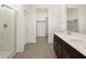 Bathroom with a dual sink vanity, tiled floors, and glass-enclosed shower and a walk-in closet at 3403 E Audrey Dr, San Tan Valley, AZ 85143