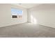 Bright bedroom featuring plush gray carpeting and a window with natural light at 3403 E Audrey Dr, San Tan Valley, AZ 85143