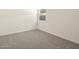 A bright, clean bedroom with neutral carpet, white walls, and a window at 3403 E Audrey Dr, San Tan Valley, AZ 85143