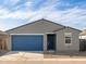 Single-story home featuring a well-maintained yard, blue garage door, and desert landscaping at 3403 E Audrey Dr, San Tan Valley, AZ 85143