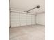 Spacious two-car garage with a clean concrete floor and white garage door at 3403 E Audrey Dr, San Tan Valley, AZ 85143