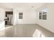 Living area featuring tile floors, natural light, and kitchen with stainless fridge at 3403 E Audrey Dr, San Tan Valley, AZ 85143