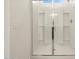 Modern glass-enclosed shower with a sleek design and built-in shelving for convenience at 3403 E Audrey Dr, San Tan Valley, AZ 85143