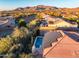 Aerial view showcasing a home with solar panels and a private pool at 40822 N Harbour Town Way, Anthem, AZ 85086